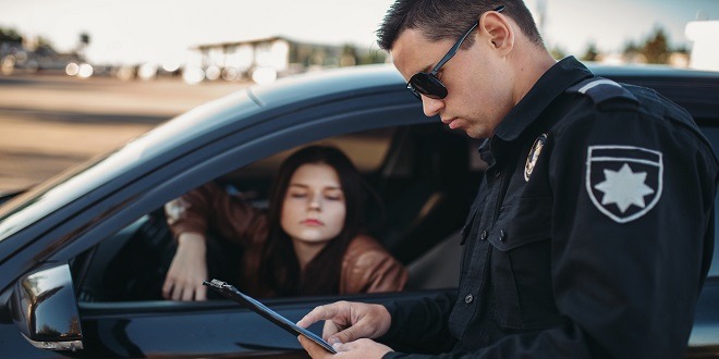 Cop in uniform checks license of female driver